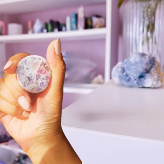 Holding a Lepidolite with Pink Tourmaline Dragon Egg